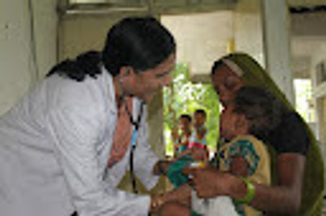 Dr. Dani examining a child patient.