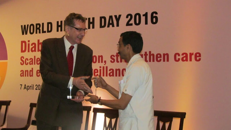 Dr. Ashish receiving WHO 'Public Health Champion' award from WHO India chief Mr. Henk Bekedam for ou