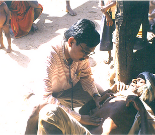 Initial field OPD: a doctor examining a patient on the ground